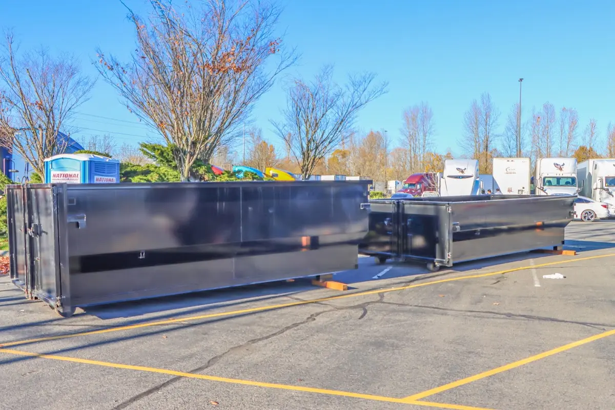 Professional dumpster rental service with roll-off container on residential driveway in Desert Hot Springs